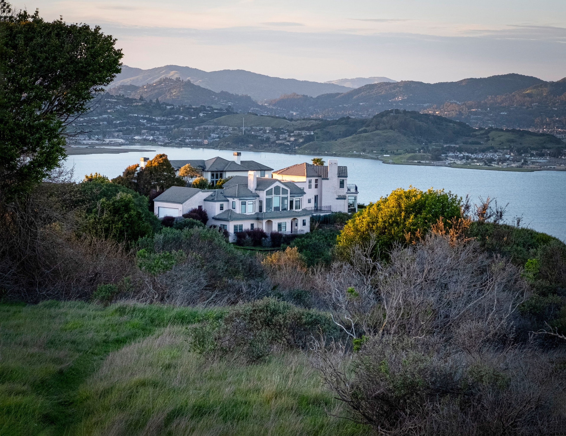 Mediterranean estate overlooking a quiet bay at golden hour